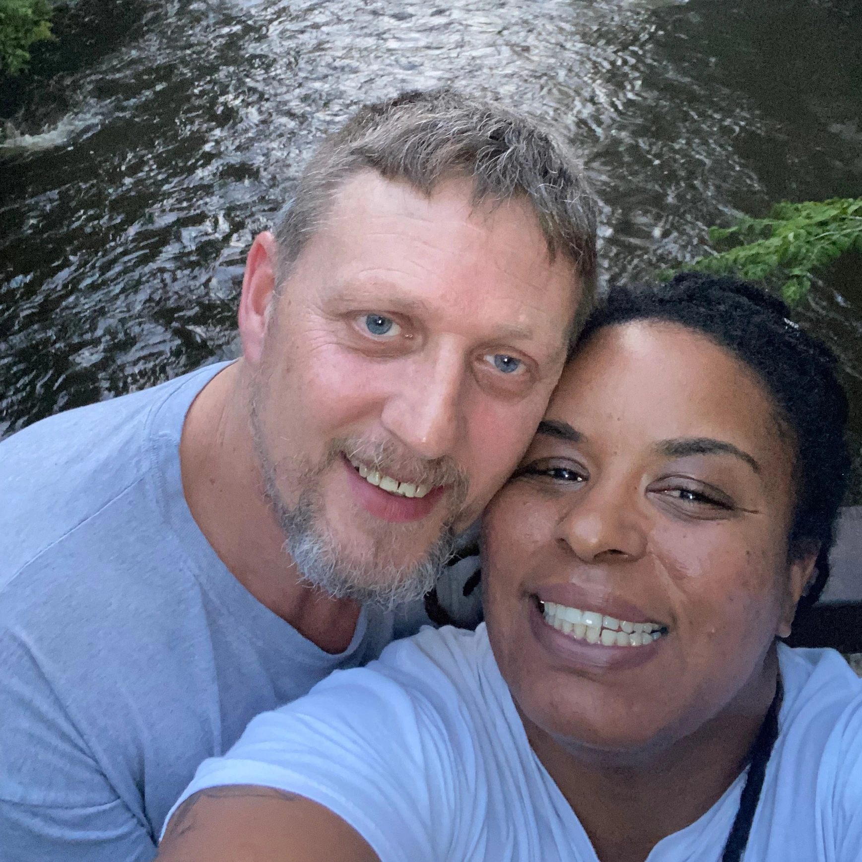 An HS patient and her husband smiling outdoors.