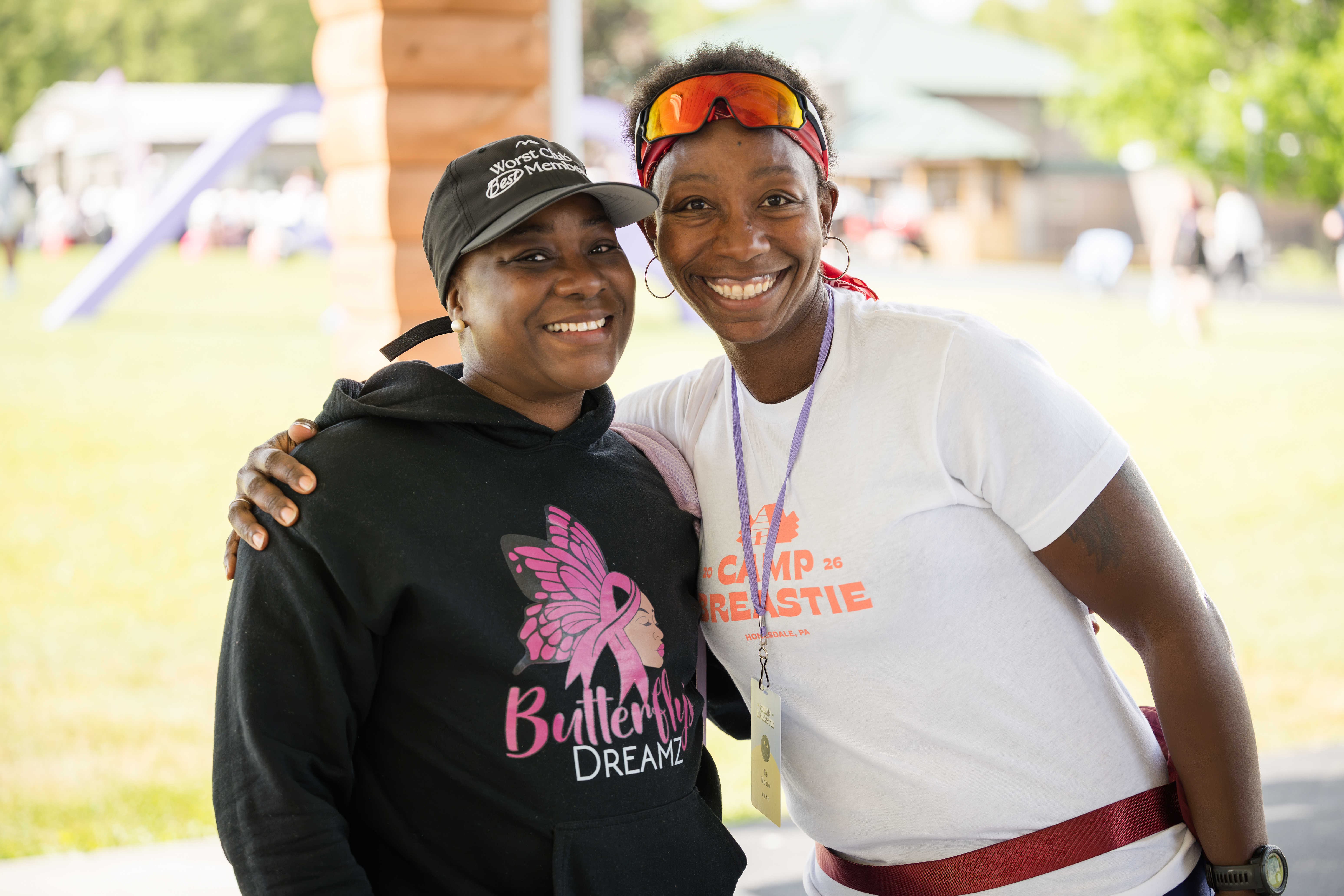 Two women smiling together at Camp Breastie.