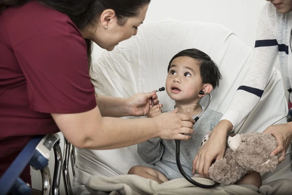 Young boy wearing stethoscope
