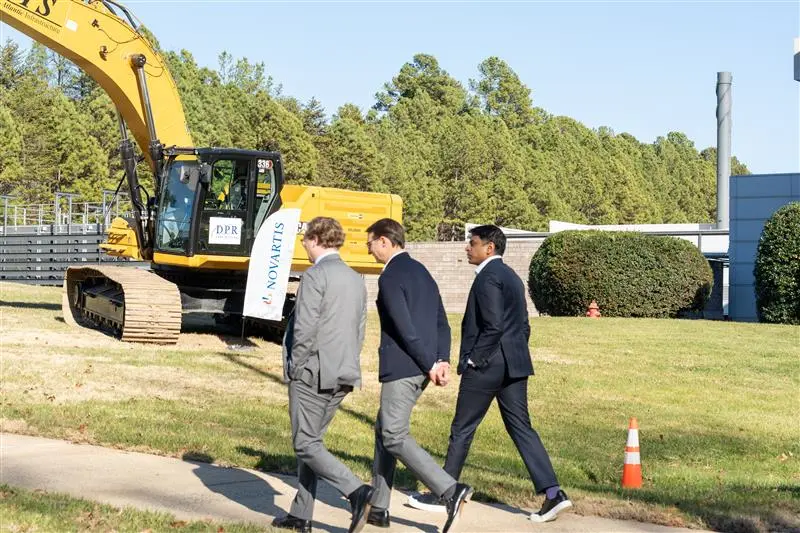 3 members of the Novartis team touring the groundbreaking site. 