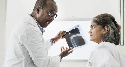 Two doctors examining X-ray