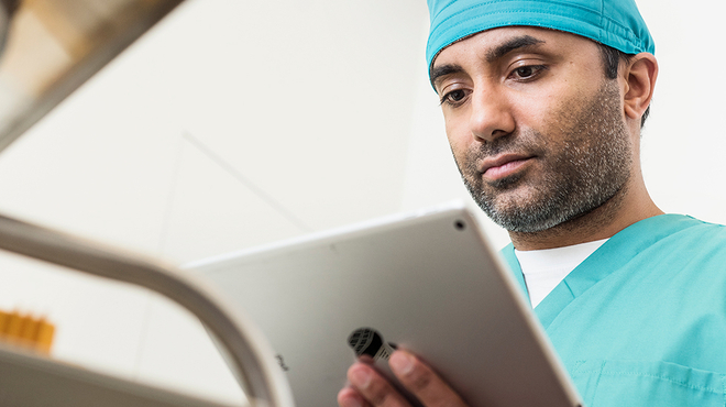Doctor looking at ipad