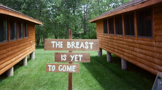 Camp Breastie cabins with a sign reading, "The Breast Is Yet To Come."